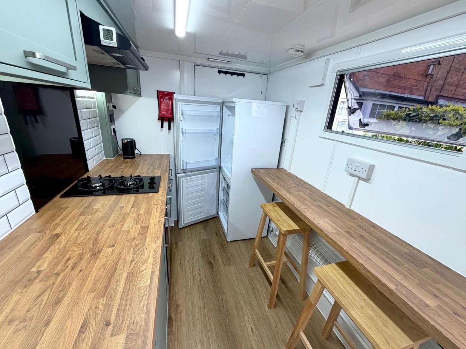 Fridge-freezer inside the kitchen pod
